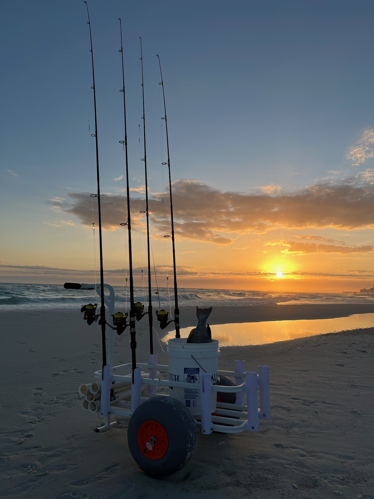 Fully loaded fishing cart with gear at sunset